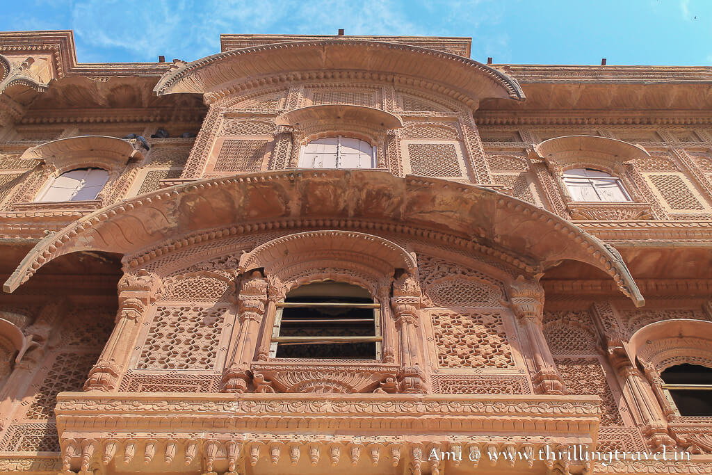 Carved windows and facade that form the backdrop of the throne kept in Shringar Chowk
