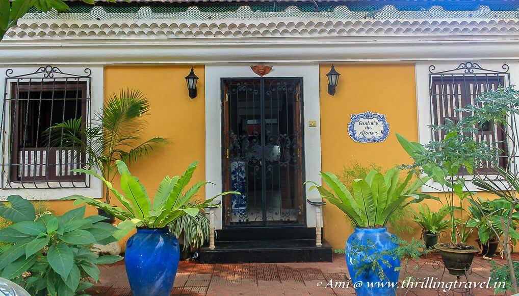 The front entrance of a Fontainhas home with a blue-tiled name plate