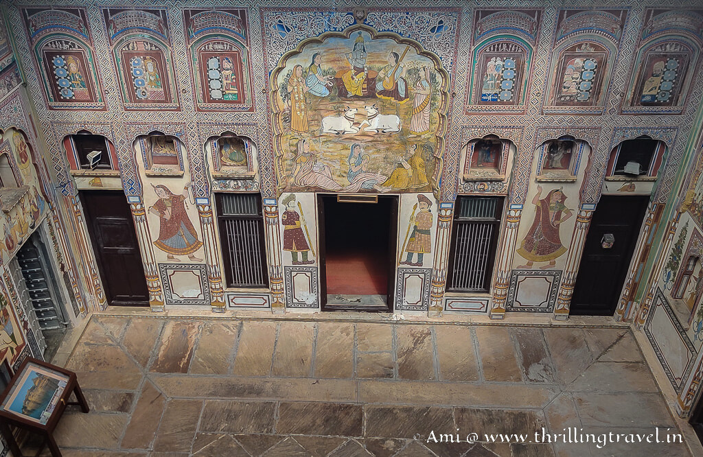 The giant fresco of Krishna playing flute in the outer courtyard