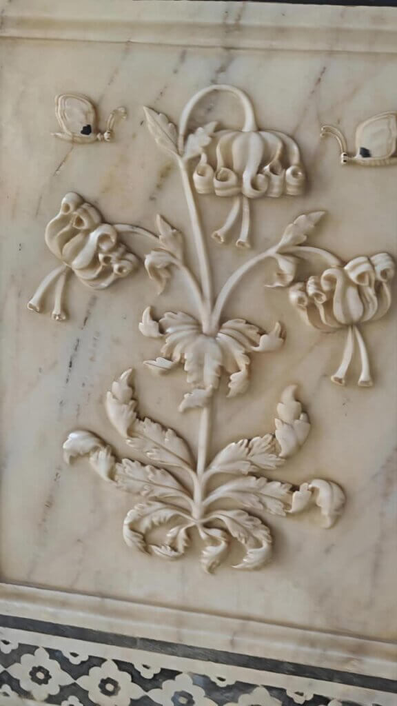 Can you spot the various images in this Magic Flower carved in the Amer Fort's Mirror Palace 