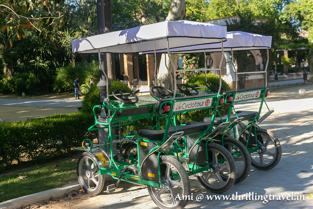 Explore the Maria Luisa Park with your family using a four-wheel cycle - one of the fun things to do in Seville with kids